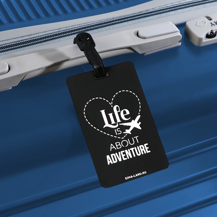 Бирка на чемодан резиновая "Life is about adventure", черная, 6.5 х 10.4 см оптом